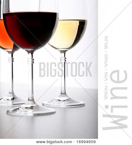 Closeup of glasses full of wine on grey background