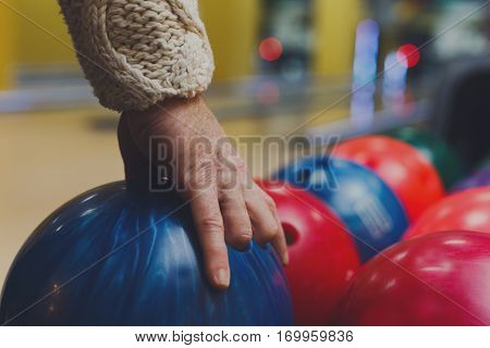 Bowling accessories background. Interior of bowling alley, lane with ball and special shoes closeup, selective focus