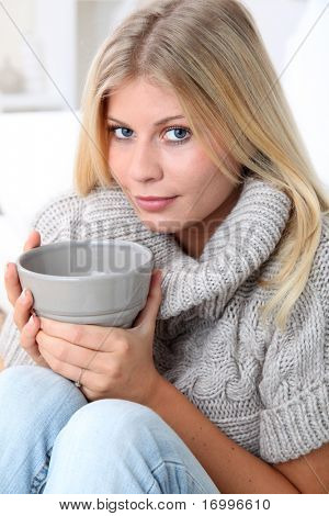 Beautiful woman drinking hot drink in winter
