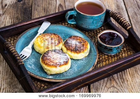 Pancakes with honey on vintage bowl on wooden tray. Studio Photo