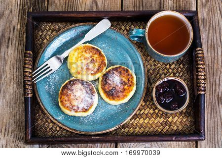 Pancakes with honey on vintage bowl on wooden tray. Studio Photo