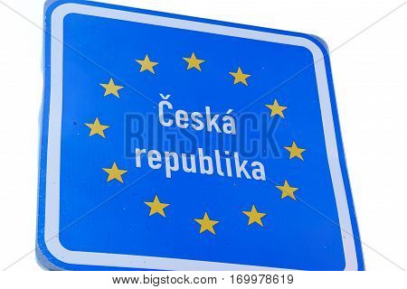Photo with Czech border sign by the road.