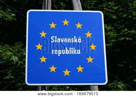 Staged photo with Slovak border sign on the road.