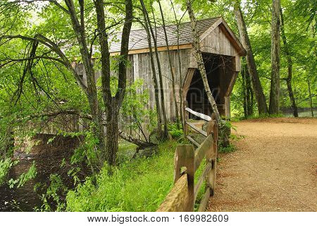 Covered bridge around the corner in the woods