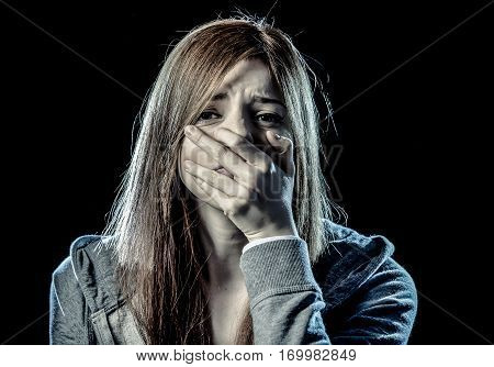 lonely young teenager girl or woman in stress and pain suffering depression looking sad and scared with fear face expression isolated on black background victim of abuse or in mental condition
