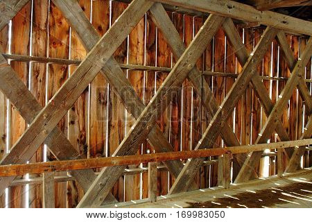 Cross hatch interior wooden bridge with sun spots