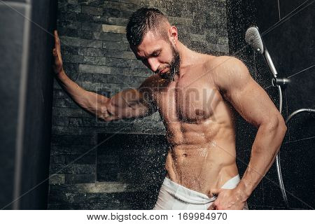 Shirtless, Muscular Man Taking A Shower In Modern Bathroom