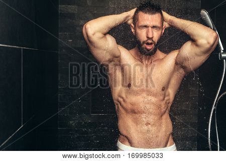 Handsome, Naked Man Taking Shower. Muscular Man Showering After Workout