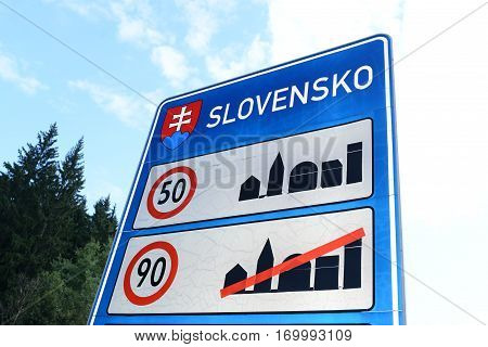 Staged photo with Slovak border sign on the road.