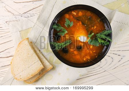 delicious saltwort soup in a black bowl and bread