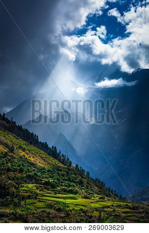 Sun rays through clouds in Himalayan valley in Himalayas. Lahaul valley, Himachal Pradesh, India