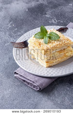 Layered Cake With Cream Napoleon Millefeuille Vanilla Slice With Mint On Dark Background.