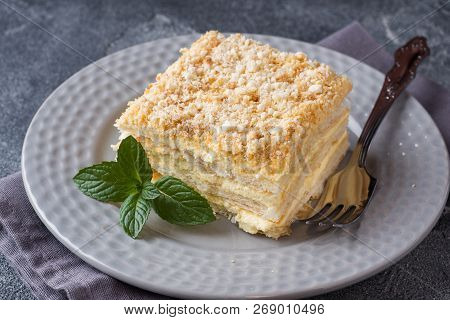 Layered Cake With Cream Napoleon Millefeuille Vanilla Slice With Mint On Dark Background.