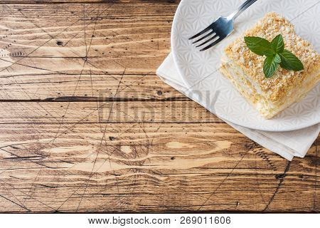 Layered Cake With Cream Napoleon Millefeuille Vanilla Slice With Mint On Wooden Background.
