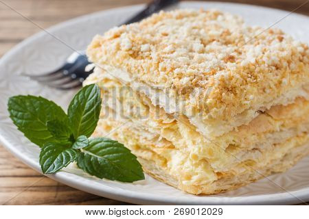 Layered Cake With Cream Napoleon Millefeuille Vanilla Slice With Mint On Wooden Background.