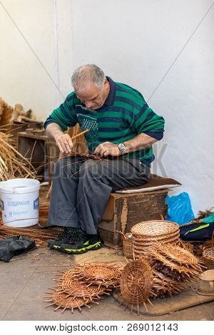 Camacha, Madeira, Portugal - April 19, 2018: A Basket Weaver At Work In The Factory Shop In Camacha 
