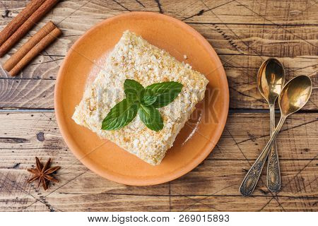 Layered Cake With Cream Napoleon Millefeuille Vanilla Slice With Mint On Wooden Background.