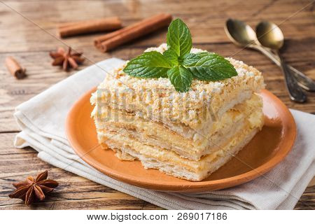 Layered Cake With Cream Napoleon Millefeuille Vanilla Slice With Mint On Wooden Background.
