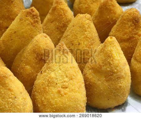 Typical Fried Sicilian Arancini Stuffed With Tomatoes And Mozzarella For Sale At The Market