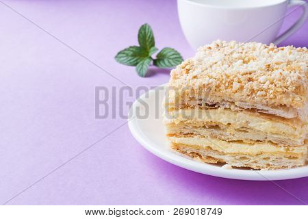 Puff Cake With Cream Napoleon Millefeuille Vanilla Slice With Mint Color On Purple Background.