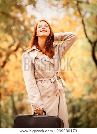Fashion Woman In Cloak With Suitcase In Autumn Season Outdoor.