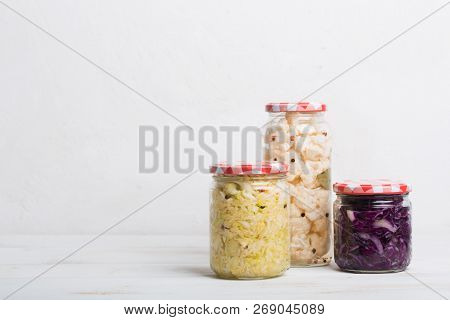 Sauerkraut In Jars On A Wooden Table