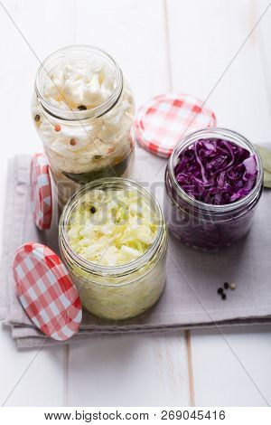 Sauerkraut In Jars On A Wooden Table. Top View