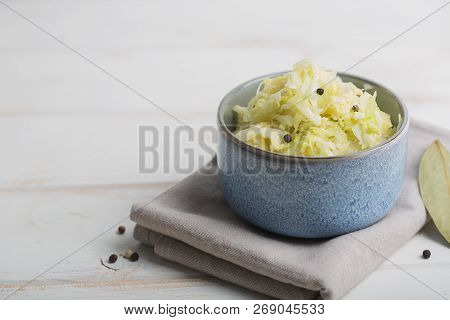 Sauerkraut In A Blue Bowl On A Wooden Table