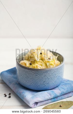 Sauerkraut In A Blue Bowl On A Wooden Table