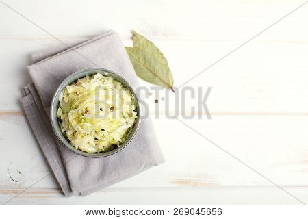 Sauerkraut In A Blue Bowl On A Wooden Table