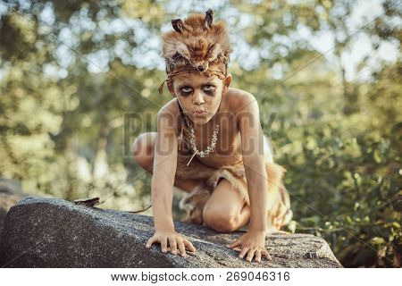 Funny Caveman, Manly Boy. Prehistoric Tribal Man Outdoors On Nature. Primitive Ice Age Man In Animal
