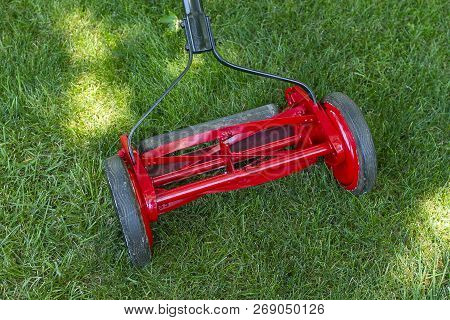 A Close Up View Of A Reel Lawnmower After The Restoration Process Was Completed