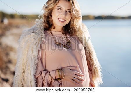 Pregnant Woman Standing Near The River While Walking