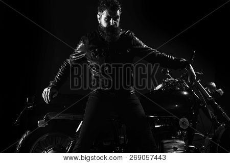 Macho, Brutal Biker In Leather Jacket Stand Near Motorcycle At Night Time, Copy Space. Man With Bear