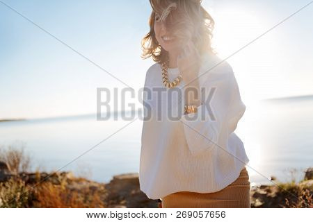 Smiling Pregnant Woman Walking Near The Water