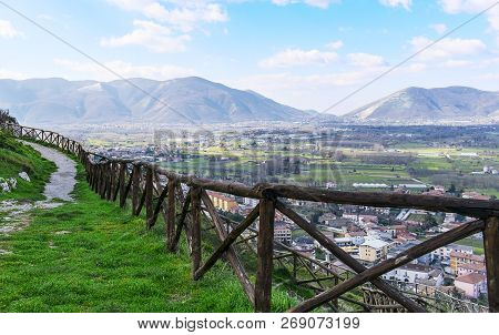 Mountain Path With A Wooden Fence On A Blue Sky Background. The Italian Apennines. Beautiful Landsca