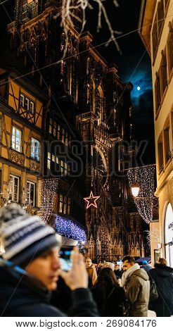 Strasbourg, France - Nov 29, 2017: Adult Male Couple Taking Photo On Smartphone Of Notre-dame Cathed