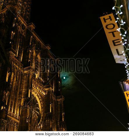 Low-angle View Of Notre-dame Cathedral And Maison Kammerzell Decorated With Christmas Lights And Ful