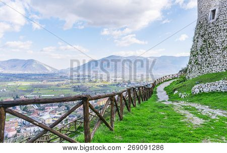 Mountain Path With A Wooden Fence On A Blue Sky Background. The Italian Apennines. Beautiful Landsca