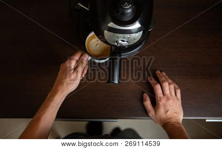 Photo Of Coffee Maker, Hands Of Man Pouring Coffee In Mug At Kitchen