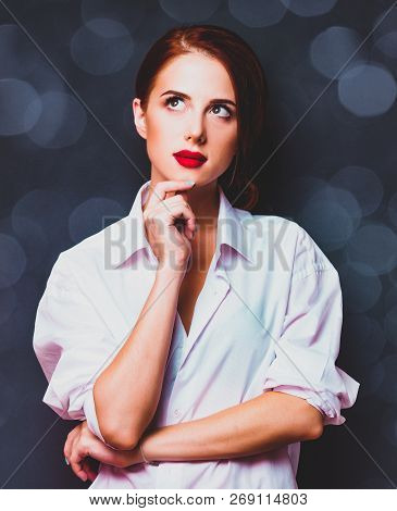 Woman In White Shirt Thinking Abouve Something On Gray Background With Bokeh