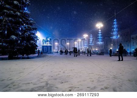 Zagreb Main Square At Night With Blue Lightened Christmas Trees During Snowing, Croatia