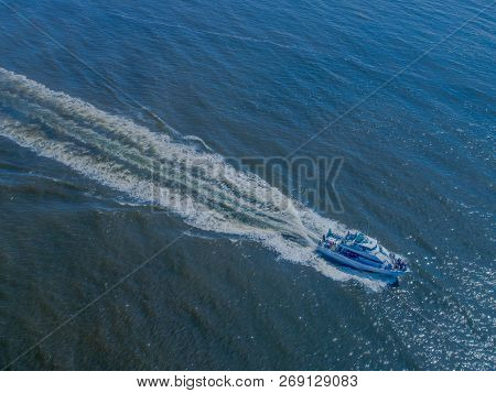 An Aerial Shot Of A Yacht Out On A Cruise, Speeding Toward Home At The End Of The Day.