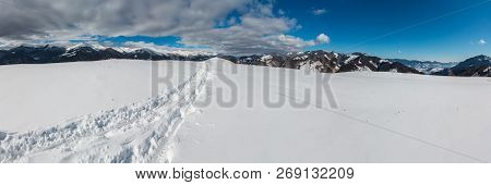 Sledge Trace And Footprints On Winter Mountain Hill Top And Snow Covered Picturesque Alp Chornohora 