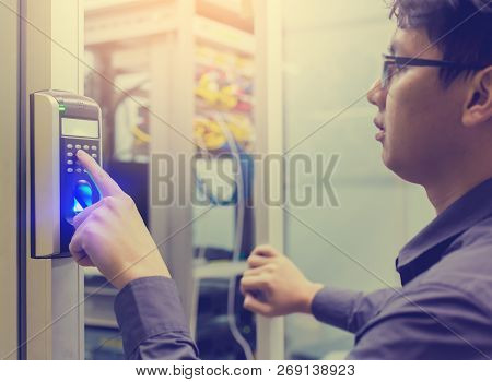 Asian Young Man Press The Button Of Electronic Control Machine With Finger Scan To Access The Door O