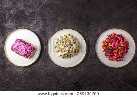 Assortment Salad Of Russian Cuisine - Olivier Salad, Vinaigrette - Beet Salad, Herring Salad.