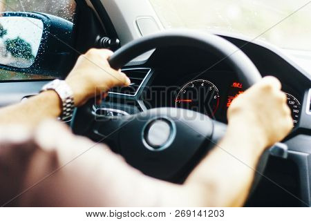 Driver With Both Hands At The Wheel Of The Car.