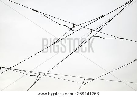 Detail of a catenary and stormy sky.