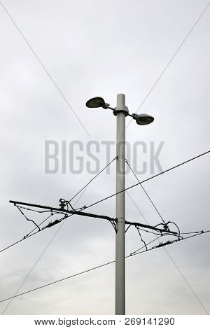 Detail of a catenary and stormy sky.