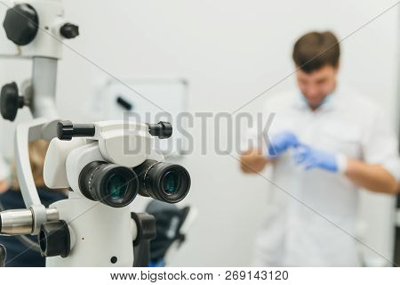 Doctor Used Microscope. Dentist Is Treating Patient In Modern Dental Office. Operation Is Carried Ou